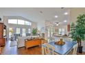 Spacious living room with hardwood floors, vaulted ceiling and access to lanai at 1453 Sunningdale Ln, Ormond Beach, FL 32174