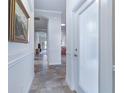Inviting foyer with an arched opening, wainscoting, and tile flooring creates a welcoming entry at 1510 Kinnard Cir, Ormond Beach, FL 32174
