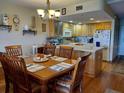 Dining area with wood table and chairs, kitchen view at 2750 Ocean Shore Blvd # 4, Ormond Beach, FL 32176