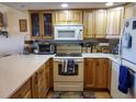 Well-equipped kitchen with light wood cabinets and appliances at 2750 Ocean Shore Blvd # 4, Ormond Beach, FL 32176