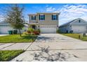 Two-story house with a two-car garage and landscaping at 447 Liu Ln, Deland, FL 32724