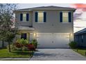 Two-story house with a two-car garage at dusk at 447 Liu Ln, Deland, FL 32724