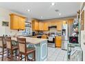 Kitchen features light wood cabinets, stainless steel appliances, and a breakfast bar at 1031 Calle Grande St, Ormond Beach, FL 32174