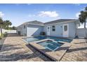 Stunning backyard featuring a sparkling pool with a spa, brick patio, and serene landscaping at 149 Sunrise Cove Cir, Ormond Beach, FL 32176