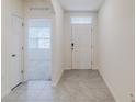 Bright and airy entryway with tile flooring and neutral tones at 200 Duke Dr, Deland, FL 32724