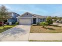 Gray house with a two-car garage and landscaped lawn at 200 Duke Dr, Deland, FL 32724