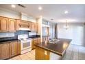 Kitchen with island, wood cabinets, and tile flooring at 718 Casper Ave, Port Orange, FL 32129