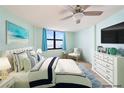 Virtually staged bedroom with ocean view and comfortable furnishings at 1415 Ocean Shore Blvd # H040, Ormond Beach, FL 32176