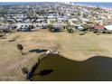 Aerial view showing the location of the property near a golf course and body of water at 200 Country Club Dr, Ormond Beach, FL 32176