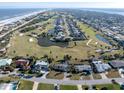 Aerial view highlighting the property's proximity to the beach and golf course at 200 Country Club Dr, Ormond Beach, FL 32176