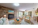 Living room with fireplace, wicker furniture and large windows at 2050 Anne Cir, South Daytona, FL 32119