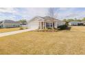 One-story house with a two-car garage and landscaping at 2212 Oconnel Dr, Ormond Beach, FL 32174