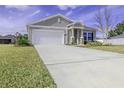 Charming single-story home featuring a well-manicured lawn and an attached two-car garage at 2212 Oconnel Dr, Ormond Beach, FL 32174