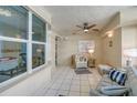 Bright sunroom with tiled floor and wicker furniture at 4565 S Atlantic Ave # 5411, Ponce Inlet, FL 32127