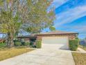 Brick home with attached garage and neatly landscaped yard at 840 Chickadee Dr, Port Orange, FL 32127