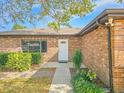 Front entrance of brick home with walkway and landscaping at 840 Chickadee Dr, Port Orange, FL 32127