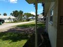 View of the home's front yard, driveway, and a tree-lined street leading to a waterfront at 105 Park Cir, Daytona Beach, FL 32117