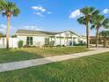 Light green house with white trim and a spacious lawn at 21 Tipperary Ln, Ormond Beach, FL 32176