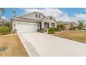 House exterior showcasing a two-car garage and manicured lawn at 2869 Monaghan Dr, Ormond Beach, FL 32174