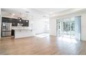 Open floor plan featuring kitchen with stainless steel appliances and large sliding glass doors at 3142 Silvermines Ave, Ormond Beach, FL 32174