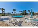 Community pool with lounge chairs and tables at 3370 Ocean Shore Blvd # 3060, Ormond Beach, FL 32176