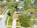 Aerial view of home with screened in pool and lush landscaping at 812 Whiporwill Dr, Port Orange, FL 32127
