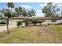 Charming single-story home with manicured shrubs and green lawn at 812 Whiporwill Dr, Port Orange, FL 32127