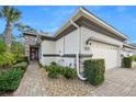 Charming home featuring a 2-car garage, well-maintained landscaping, and a beautiful stone facade at 820 Aldenham Ln, Ormond Beach, FL 32174