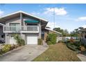 Two-story townhome with attached garage and balcony at 135 Lagoon Ct, New Smyrna Beach, FL 32169