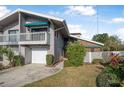 Two-story townhome with attached garage and balcony at 135 Lagoon Ct, New Smyrna Beach, FL 32169