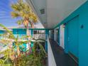 Bright hallway with teal walls, leading to condo units at 2596 Tulane Ave # 4, Daytona Beach, FL 32118