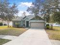 Charming single-story home with well-maintained lawn, fresh landscaping, and a two-car garage at 46 Chrysanthemum Dr, Ormond Beach, FL 32174