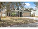 Charming single-story home with well-maintained lawn, fresh landscaping, and a two-car garage at 46 Chrysanthemum Dr, Ormond Beach, FL 32174