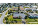 Bird's eye view of the house in a quiet neighborhood with palm trees and fenced yards at 100 Lynnhurst Dr, Ormond Beach, FL 32176