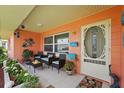 Inviting front porch with comfortable seating, decorative accents, and colorful details at 100 Lynnhurst Dr, Ormond Beach, FL 32176