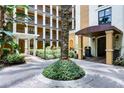 Exterior courtyard featuring beautiful landscaping, plants, and manicured shrubbery at 12544 Floridays Resort Dr # 507-B, Orlando, FL 32821