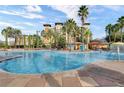 Exterior community pool surrounded by lounge chairs, palm trees, and a splash pad at 12544 Floridays Resort Dr # 507-B, Orlando, FL 32821