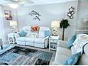 Comfortable living room with white couches, decorative pillows, and stylish decor at 1575 Ocean Shore Blvd # 205, Ormond Beach, FL 32176