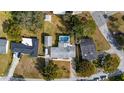 A bird's eye view of the home shows an in-ground pool, driveway, and peaceful residential area at 1705 Cordova Ave, Daytona Beach, FL 32117