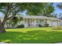Charming single-story home boasting a cozy front porch, well-kept lawn and attractive landscaping at 1705 Cordova Ave, Daytona Beach, FL 32117