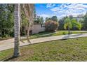 Charming home exterior with a quaint yard and concrete driveway on a sunny day at 630 W Rich Ave, Deland, FL 32720