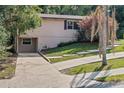 Charming home exterior with a quaint yard and concrete driveway on a sunny day at 630 W Rich Ave, Deland, FL 32720