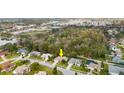 Overhead view of a residential neighborhood, showing the house with trees and nearby community amenities at 66 Old Sunbeam Dr, South Daytona, FL 32119