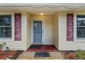 Close up on the entryway with a screen door and decorative shutters, perfect for making a great first impression at 1054 W Samms Ave, Port Orange, FL 32129