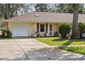 Cozy home with a well-maintained lawn, attached garage, and a welcoming entrance, perfect for first-time buyers at 1054 W Samms Ave, Port Orange, FL 32129
