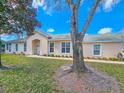 Charming single-story home with a well-maintained lawn and mature tree in the front yard at 1187 Athlone Way, Ormond Beach, FL 32174