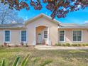 Attractive single-story home featuring a covered entrance and manicured front yard at 1187 Athlone Way, Ormond Beach, FL 32174