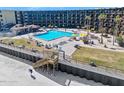 Exterior view of pool with lounge chairs and umbrellas near the beach at 2301 S Atlantic Ave # 230, Daytona Beach, FL 32118