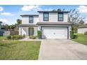 Charming two-story home featuring a manicured lawn and a convenient two-car garage at 348 Southern Winds Blvd, Deland, FL 32720