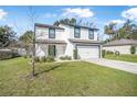 Charming two-story home with a two car garage and lush green lawn at 348 Southern Winds Blvd, Deland, FL 32720